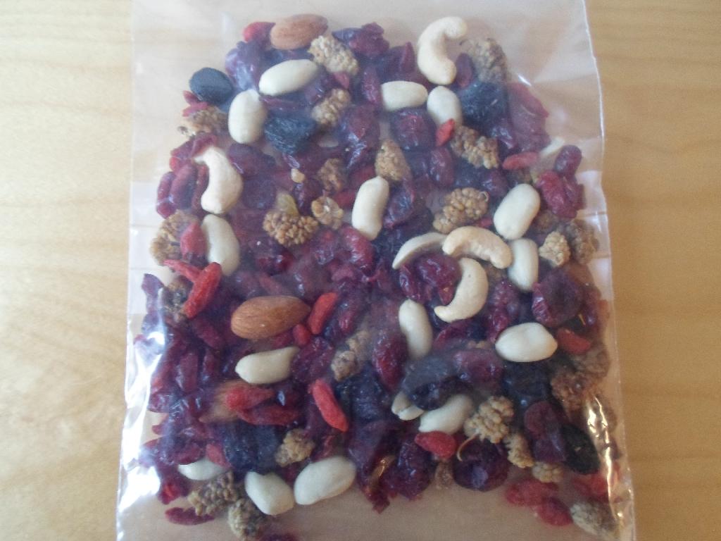 Produktet består ifølge den med anmodningen medsendte vareprøve af en blanding af: 
•	35,6 % tranebær (61 % ananasjuicekoncentrat, 38 % tranebær, solsikkeolie),
•	15,5 % usaltede peanuts,
•	9,2 % jumborosiner (99,5 % rosiner, solsikkeolie),
•	18,1 % tørrede gojibær (99,95 % gojibær, konserveringsmiddel; E220 (svovldioxid)),
•	11,5 % morbær,
•	5,4 % cashewnøddekerner,
•	4,8 % mandler. 

Varen foreligger i detailsalgspakning (1 kg og derunder).