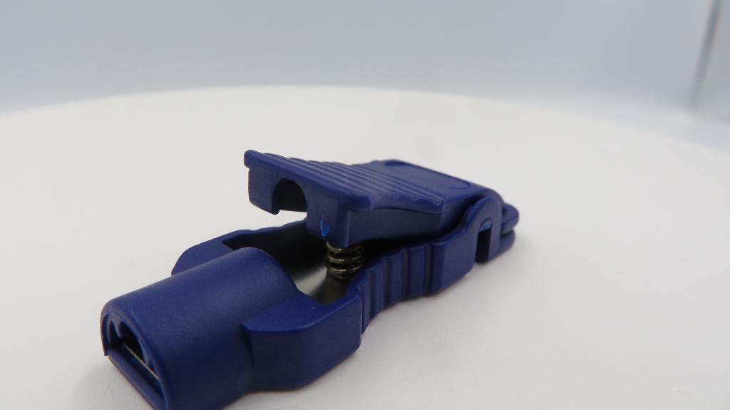 Varen er en konnektorklemme, som åbnes ved at trykke ned på en fjederaktiveret knap i midten af varen. I den ene ende af varen er klemmedelen, mens der i den anden ende er en indgang til et 3 mm stik. Inde i varen er der en metalplade i hele længden.
Det er oplyst, at varen anvendes til at skabe en sikker forbindelse mellem en EKG-elektrode og et kabel. Forbindelse sker ved, at varen sættes på elektroden, så den klemmer om elektroden, hvorefter et kabel med et 3 mm stik kan sættes i indgangen dertil.
Varen består efter det oplyste af plast og metal.
Varen er oplyst til at kunne anvendes op til 50 gange. Den er pakket i detailsalgsemballage indeholdende 10 clips.
Varen har målene 32 mm x 18 mm på det bredeste sted.