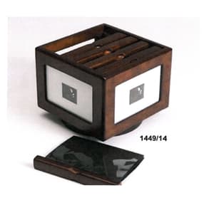Caja de madera con tapa. En los cuatro lados laterales y  en la tapa la madera está recortada de forma cuadrada o rectangular para incorporar fotos y está protegida con vidrio. La caja tiene en su interior cinco fundas de plástico unidas por un soporte de madera. Cada funda tiene doce hojas de plástico dobles.
La caja tiene unas medidas de 18x 19x 23cm