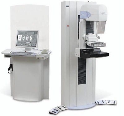 Aparato de rayos X computerizado (tomografía regida por una máquina automática de tratamiento o procesamiento de datos) formado por los dos cuerpos que aparecen en la fotografía.
Está indicado para generar imágenes mamográficas digitales 2D y 3D. Se comercializa directamente a hospitales y clínicas.