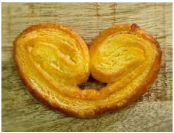 Palmerita de hojaldre. Producto de bollería sin gluten. Contiene más de un 5% de sacarosa en peso. Se presentan envasados en paquetes de 8 unidades, en envase de polipropileno biorientado, unidad de 20 gramos, en cajas de 1.920 gramos (12 paquetes por caja).
Apto para la alimentación humana. El aceite de palma utilizado está certificado bajo el esquema RSPO, que garantiza la sostenibilidad del mismo.