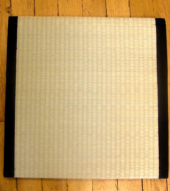 OUVRAGE DE VANNERIE À POSER SUR LE SOL, DE FORME CARRÉE, DE DIMENSIONS 48 X 48 X 7 CM, COMPOSÉ D'UNE FACE TRESSÉE DE MATIÈRE VÉGÉTALE (JONC),  D'UNE ÉPAISSE COUCHE DE PAILLE DE RIZ COMPRESSÉE ET D'UNE FACE EN MATIÈRE PLASTIQUE TRESSÉE QUI EST RAPPORTÉE PAR COUTURE.

L'ARTICLE PRÉSENTE DEUX BORDURES RENFORCÉES PAR UNE BANDE DE TOILE DE COTON ET N'EST PAS OBTENU DIRECTEMENT EN FORME.