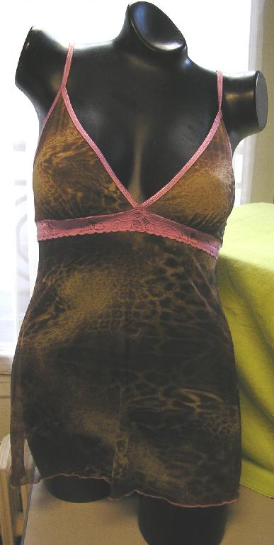 COMBINAISON POUR FEMMES EN TULLE DE FIBRES SYNTHÉTIQUES (69% POLYESTER - 31% LYCRA), IMPRIMÉ, DESCENDANT JUSQU'À LA MI-CUISSE, PRÉSENTANT UN PROFOND DÉCOLLETÉ EN V BORDÉ PAR UN GALON DE COULEUR CONTRASTÉE QUI SE PROLONGE PAR DE FINES BRETELLES ÉLASTIQUES ET COMPORTANT UNE BANDE DE DENTELLE DE COULEUR CONTRASTÉE RAPPORTÉE SOUS LA POITRINE.

LA BASE DE LA COMBINAISON PRÉSENTE UN SURFILAGE DE COULEUR CONTRASTÉE.