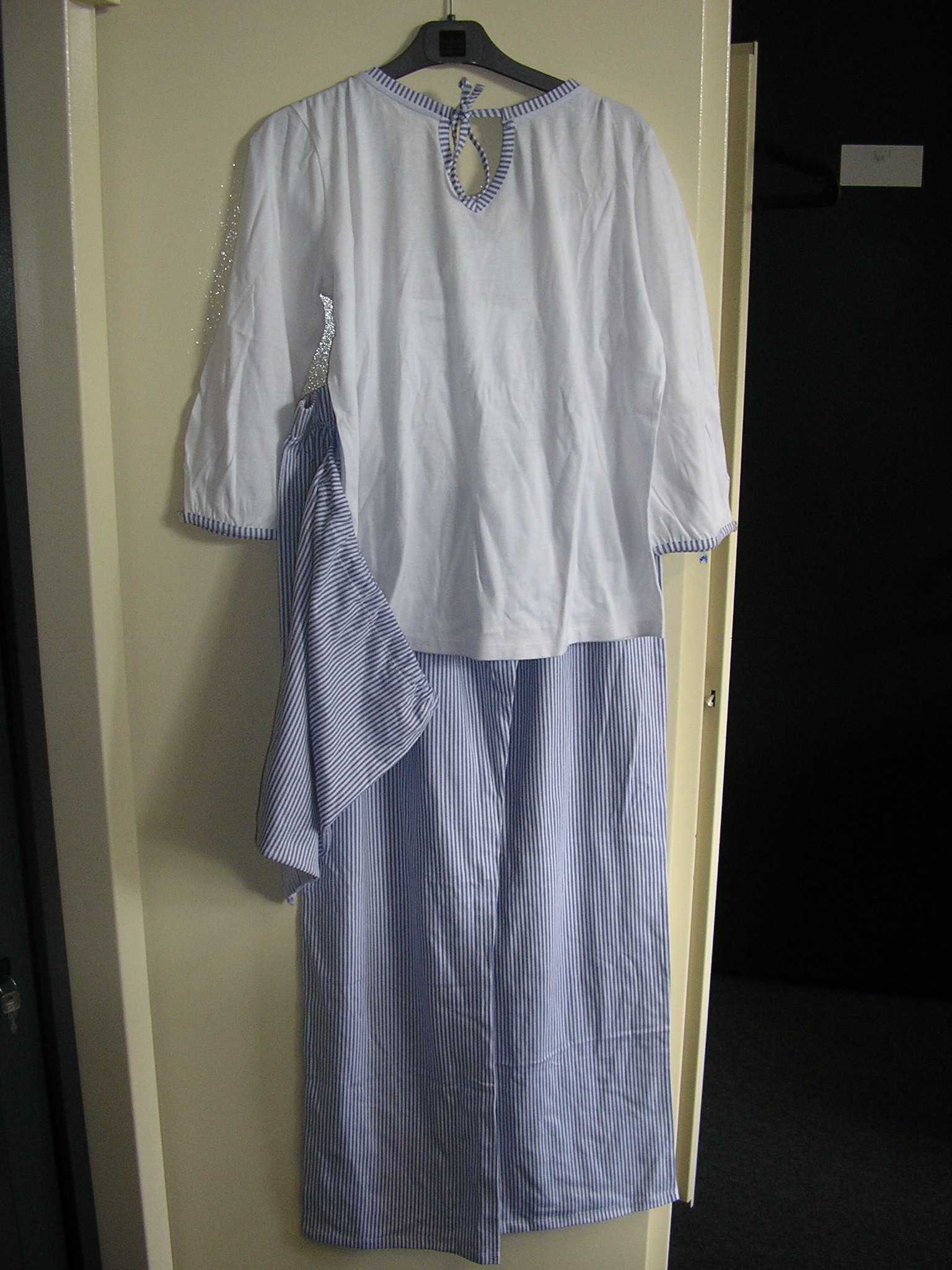 PYJAMA POUR FEMME, CONFECTIONNÉ EN ÉTOFFE DE BONNETERIE DE COTON (100%), COMPOSÉ DE DEUX ÉLÉMENTS :
- UN VÊTEMENT DE TYPE TEE-SHIRT, DESTINÉ À COUVRIR LA PARTIE SUPÉRIEURE DU CORPS, DESCENDANT JUSQU'AUX HANCHES, COMPORTANT DES MANCHES 3/4 DONT LES EXTRÉMITÉS PRÉSENTENT UNE FENTE MUNIE D'UN PETIT BOUTON DÉCORATIF A LA BASE, AVEC UNE ENCOLURE ARRONDIE AGRÉMENTÉE D'UN COL EN V EN SON MILIEU, AVEC UN LIEN A NOUER AU NIVEAU DU COL, AVEC UN OURLET A LA BASE ET UN BIAIS DE LA MÊME ÉTOFFE QUE LE PANTALON AUX EXTRÉMITÉS DES MANCHES ET A L'ENCOLURE.

- UN PANTALON DESCENDANT JUSQU'AUX CHEVILLES, SANS OUVERTURE, COMPORTANT UNE BANDE ÉLASTIQUÉE À LA TAILLE, UN OURLET À LA BASE ET TROIS PETITS BOUTONS DÉCORATIFS SUR LE DEVANT.

LE PYJAMA EST PRÉSENTÉ POUR LA VENTE AU DÉTAIL DANS UNE POCHETTE EN ÉTOFFE DE BONNETERIE DE COTON SE FERMANT AU MOYEN D'UN LIEN COULISSANT A NOUER SUR LE DESSUS.