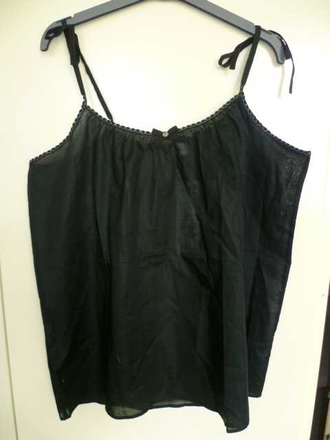 BLOUSE POUR FEMMES, GENRE CARACO, CONFECTIONNÉ EN TISSU DE COTON, DESTINÉ A RECOUVRIR LE HAUT DU CORPS, DESCENDANT JUSQU'AUX HANCHES, LÉGÈREMENT TRANSPARENTE, DE FACTURE LÉGÈRE ET ÉVASÉE. CE VÊTEMENT COMPORTE DE FINES BRETELLES QUI SE NOUENT SUR LE DESSUS, UNE ENCOLURE DROITE ET DES EMMANCHURES BORDÉES D'UN BIAIS COUSU DE FILS DORÉS, UN NŒUD DÉCORATIF AU CENTRE DE L'ENCOLURE ET UN OURLET A LA BASE.