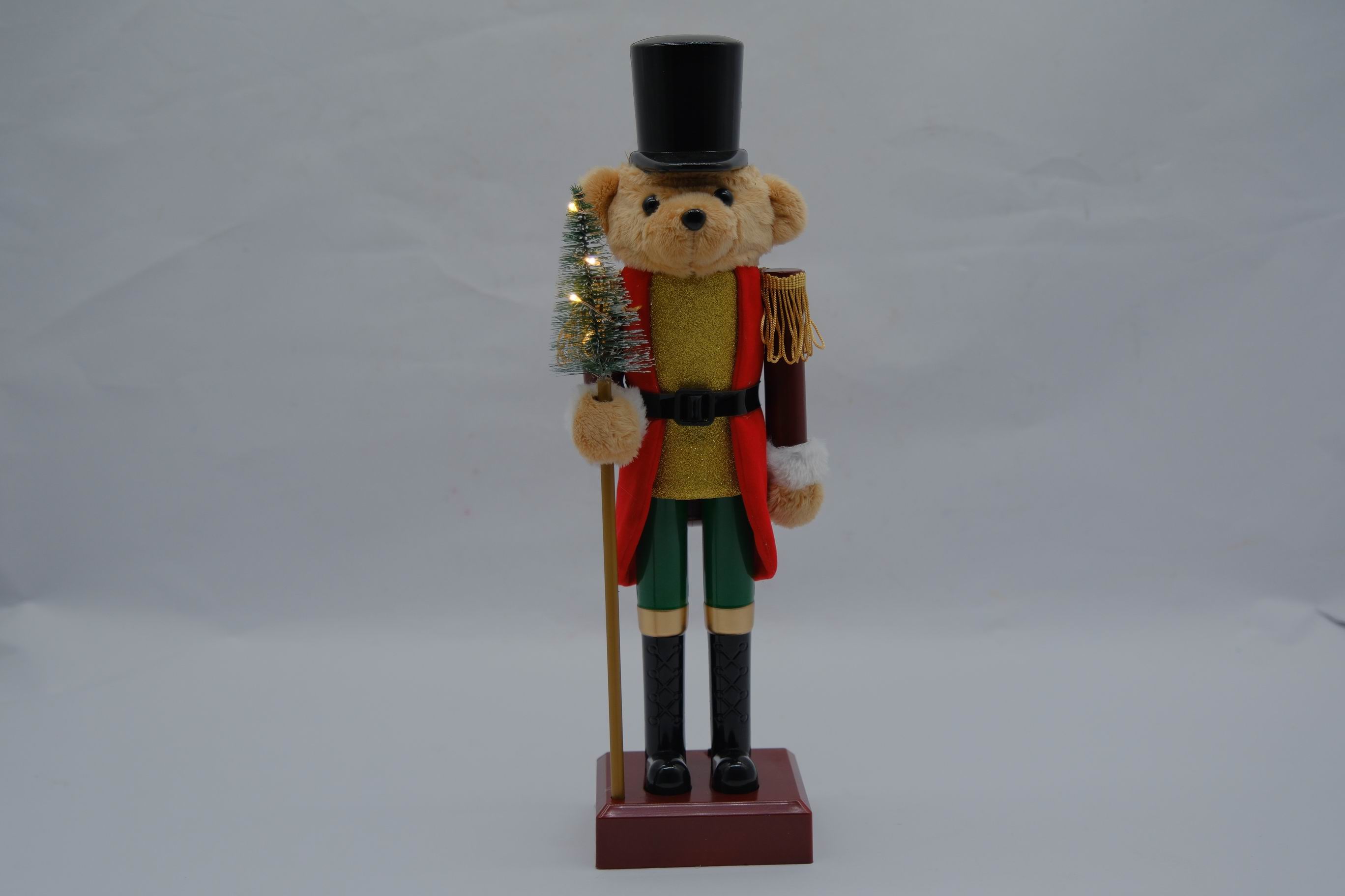 Décoration ours habillé en casse-noisette, tenant un sapin éclairé avec quelques LED.

Article de décoration représentant un ours habillé en garde anglais, tenant un sapin éclairé avec quelques LED.
Socle et jambes en plastique (ABS). Tête et vêtements en textile, bonneterie. Les LED fonctionnent à piles.
Hauteur : 40 cm