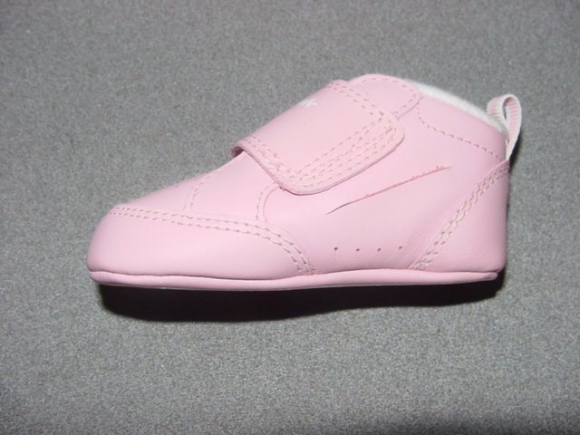 INFANTS/BABIES TRAINER STYLE BOOT. UPPERS OF RED LEATHER. OUTER SOLES OF LEATHER. COVERING THE ANKLE BUT NO PART OF THE CALF. INSOLE LENGTH LESS THAN 24CMS. WITH VELCRO FASTENING STRAP. COMPANY LOGO ON STRAP AND OUTER SOLE.