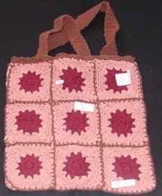 A  BAG MADE OF CROCHETED SQUARES WITH A MOTIF IN THE MIDDLE OF EACH SQ
UARE IN A CONTRASTING COLOUR. WITH HANDLES AND EDGING  IN A CONTRASTIN
G COLOUR.  MEASURING 27 CMS. X 29 CMS. APPROX.  100% COTTON.
