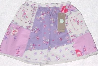 A WOVEN COTTON SKIRT FOR GIRLS. VARIOUS PRINTED FABRICS SEWN TOGETHER
IN A  PATCHWORK, WITH SEQUINS SEWN TO ALL SEAMS. WAISTBAND IS ELASTICA
TED AT BACK. HEMMED AT BASE, WITH APPLIED LACE TRIM.