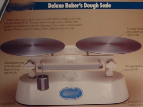 A SET BAKERS DOUGH SCALES MADE OF CAST IRON WITH A PAINTED BASE, STAINLESS STEEL PLATTERS, STAINLESS STEEL POISE AND BEAM AND RUBBER FOOT PADS.  COMES COMPLETE WITH A SCOOP AND WEIGHTS.  FOR COMMERCIAL USE.