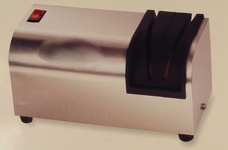 AN ELECTRIC KNIFE SHARPENER CONSTRUCTED OF A STAINLESS STEEL CASE AND  PLASTIC KNIFE GUIDES.  LIGHTED ROCKER SWITCH INDICATES WHEN MOTOR IS RUNNING.