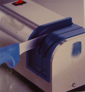 A 115/230 VOLTS ELECTRIC KNIFE SHARPENER CONSTRUCTED OF A STAINLESS STEEL CASE AND  PLASTIC KNIFE GUIDES.