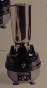 A 120V BLENDER, CONSTRUCTED OF ZINC ALLOY PAINTED BASE IN GREY, WITH BLACK PLASTIC COVER.  A 44 OUNCE POLYCARBONATE CONTAINER WITH A BLACK PLASTIC LID, WEIGHT 8LBS AND HEIGHT 14 3/4 INCHES.  FOR COMMERCIAL USE.