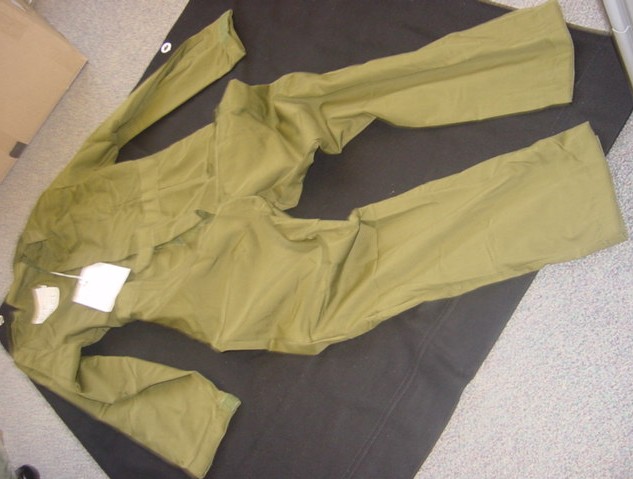 A WOVEN INDUSTRIAL AND OCCUPATIONAL COVERALL FOR MEN.  DESIGNED TO COVER THE BODY FROM THE SHOULDERS TO THE ANKLES.  WITH A ROUND NECK WITH A COLLAR.  WITH A FRONT OPENING FROM THE NECK TO THE CROTCH WHICH HAS A LEFT OVER RIGHT VELCRO FASTENING.  WITH LONG SLEEVES WITH  VELCRO TIGHTENING AT THE CUFFS.  WITH A LEFT HAND BREAST POCKET AND THIGH POCKET WITH VELCRO FLAPS.  WITH A SLIT POCKET OPENING EACH SIDE AT HIP LEVEL WITH A VELCRO FASTENING.  WITH A LEFT OVER RIGHT VELCRO TAB AT WAIST LEVEL AT FRONT AND VELCRO TABS FOR TIGHTENING AT BACK.  WITH EPAULETTES ON SHOULDERS.  HEMMED AT SLEEVE AND LEG ENDS.  67% POLYESTER. 33% COTTON.  PACKAGED IN A POLY BAG FOR RETAIL SALE.