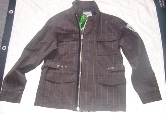 A WOVEN SAFARI STYLE JACKET FOR MEN.  REACHING TO BELOW THE WAIST. WITH  A ZIP FASTENER WITH A LEFT OVER RIGHT STORM FLAP FASTENED WITH ANOTHER ZIP. WITH FOUR POCKETS TO FTONT, WITH POPPERED FLAPS. WITH A COLLAR. WITH LONG SLEEVES, WITH APPLIED CUFFS. WITH A MATCHING BELT WHICH IS ATTACHED AT SIDES WITH ADJUSTABLE POPPERS. PADDED AND LINED. 100% COTTON.