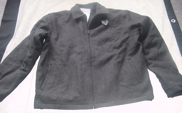 WOVEN JACKET FOR MEN. CONSTRUCTED OF BOILED FABRIC. INTENDED TO COVER THE UPPER PART OF THE BODY FROM THE SHOULDERS REACHING BELOW THE WAIST. WITH LONG SLEEVES, WITH APPLIED CUFFS FASTENING WITH PRESS STUDS.  WITH COMPLETE FRONT OPENING FASTENING WITH ZIP. WITH FLAP UNDERNEATH THE COLLAR, FASTENING LEFT OVER RIGHT WITH SINGLE BUTTON. FULLY LINED. WITH TWO POCKETS ON LOWER FRONT AND THREE INNER POCKETS. HEMMED AT THE BASE. WITHOUT ANY MEANS OF TIGHTENING. OF 90% WOOL AND 10% ACRYLIC.
