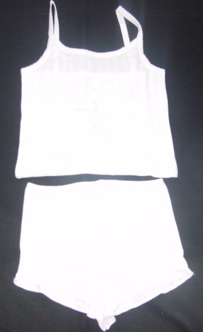 A KNITTED ENSEMBLE FOR LADIES. UPPER GARMENT IS SIMILAR TO A VEST. WITH A SCOOP NECK AND SHOULDER STRAPS WTIH PICOT EDGING. HEMMED AT BASE. RIBBON DRAWSTRING TO WAIST. LOWER GARMENT IS A PAIR OF SHORTS, WTIH AN ELASTICATED WAIST. OVERLOCKING TO LEG OPENINGS. DECORATIVE BOW TO WAIST. 100% COTTON POINTELLE. PACKAGED IN A HANGING POLYBAG WITH PRINTED CARD INSERT.