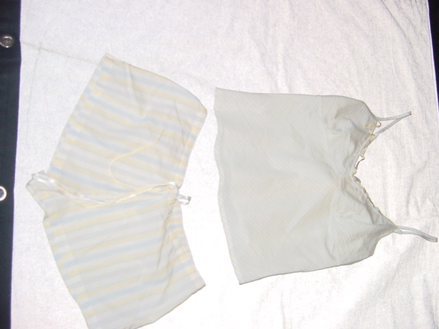 WOVEN PYJAMAS FOR WOMEN.  CONSISTING OF A CAMI STYLE UPPER GARMENT. V-NECK, WITHOUT OPENING.  WITH ADJUSTABLE SHOULDER STRAPS.  HEMMED AT BASE.  WITH RIBBON DECORATION AT NECKLINE.  PACKED WITH SHORTS.  CONSTRUCTED OF CO ORDINATING BLUE AND YELLOW STRIPED FABRIC.  ELASTICATED AT BACK OF WAIST. WITH RIBBON DRAWSTRING AT FRONT.  HEMMED AT LEG ENDS. 100% COTTON