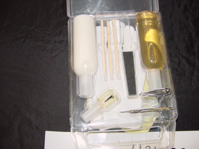 MANICURE SET. CONTAINING HAND GEL, HAND LOTION, CLEAR EMERY BOARD, WOOD CUTICLE STICKS, CLEAR NAIL VARNISH, METAL SCISSORS, METAL CLIPPERS, COTTON GLOVES (CLASSIFIED SEPARATELY). PACKAGED FOR RETAIL SALE IN A CLEAR PLASTIC CONTAINER WITH HANDLES.