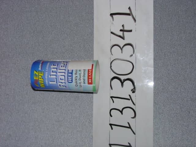 LINT ROLLER REFILL.  MADE OF PAPER, COATED ON ONE SIDE WITH PLASTIC AND SELF-ADHESIVE ON THE OTHER.  ON A ROLL WITH PERFORATED LINES.  DESIGNED TO BE MOUNTED ONTO A PLASTIC HANDLE, NOT PROVIDED, AND USED TO REMOVE LINT, DUST, PET HAIR AND DANDRUFF FROM FABRICS.