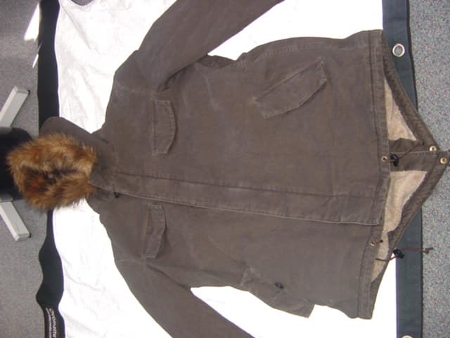 A WOVEN PARKA FOR MEN. WEIGHT 1667KG. DESIGNED TO COVER THE UPPER PART OF THE BODY FROM THE SHOULDERS TO MID THIGH. WITH A COMPLETE FRONT OPENING WITH ZIP AND LEFT OVER RIGHT BUTTON FASTENING. WITH A HOOD THAT HAS A DRAWSTRING TIGHTENING AND  DETACHABLE FUR TRIM. WITH LONG SLEEVES. WITH PRESS STUD FASTENING AT SLEEVE ENDS. WITH VARIOUS POCKETS ON THE FRONT OF THE GARMENT. WITH DRAWSTRING TOGGLE TIGHTENING AT THE WAIST AND BASE OF THE GARMENT. WITH FUR ON THE INSIDE. 100% COTTON