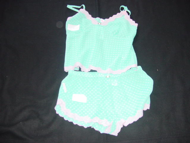 A PAIR OF WOVEN BABY DOLL PYJAMAS FOR LADIES. UPPER IS A CAMISOLE, WITH ADJUSTABLE SHOULDER STRAPS. WITH A V-NECK. WITH SHAPED CUPS. WITH LACE TRIM AROUND THE TOP AND BASE OF GARMENT. SHORTS HAVE AN ELASTICATED WAIST WITH LACE TRIM AT LEG ENDS. 100% POLYESTER.