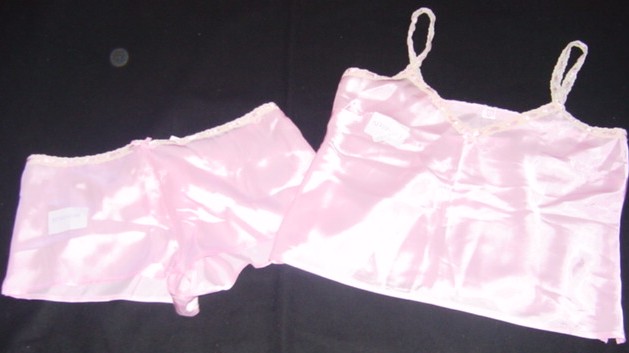 A PAIR OF WOVEN BABY DOLL STYLE PYJAMAS FOR WOMEN.   COMPRISING AN UPPER GARMENT REACHING DOWN TO THE HIPS.  WITH A V-NECK  WITHOUT OPENING.  WITH NARROW LACE AND RIBBON SHOULDER STRAPS.  WITH DECORATIVE BOW AT CLEAVAGE. WITH DECORATIVE LACE AND RIBBON AROUND THE NECKLINE AND ARMHOLE EDGE.  HEMMED AT THE BASE. WITH 5CM VENTS EACH SIDE.  THE  LOWER GARMENT REACHES DOWN TO THE TOP OF THE THIGH.  ELASTICATED AT THE BACK OF THE WAIST WITH DECORATIVE LACE AND RIBBON AT THE FRONT.  WITHOUT OPENING.  LOOSE FIT.  HEMMED AT THE LEG OPENINGS.  WITH 3CM  VENTS EACH SIDE.  100% POLYESTER.