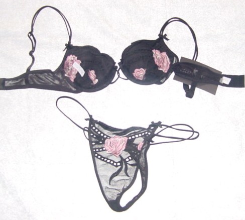 A KNITTED BRA AND BRIEF SET. THE UPPER GARMENT IS AN UNDERWIRED BRA. SLIGHTLY PADDED. WITH EMBROIDERED FLOWER DETAIL. WITH BOWS ATTACHED. WITH BACK HOOK AND EYE FASTENING. THE LOWER GARMENT IS A THONG BRIEF. WITH A LINED GUSSET. PACKAGED TOGETHER FOR RETAIL SALE. 90% NYLON, 10% SPANDEX.