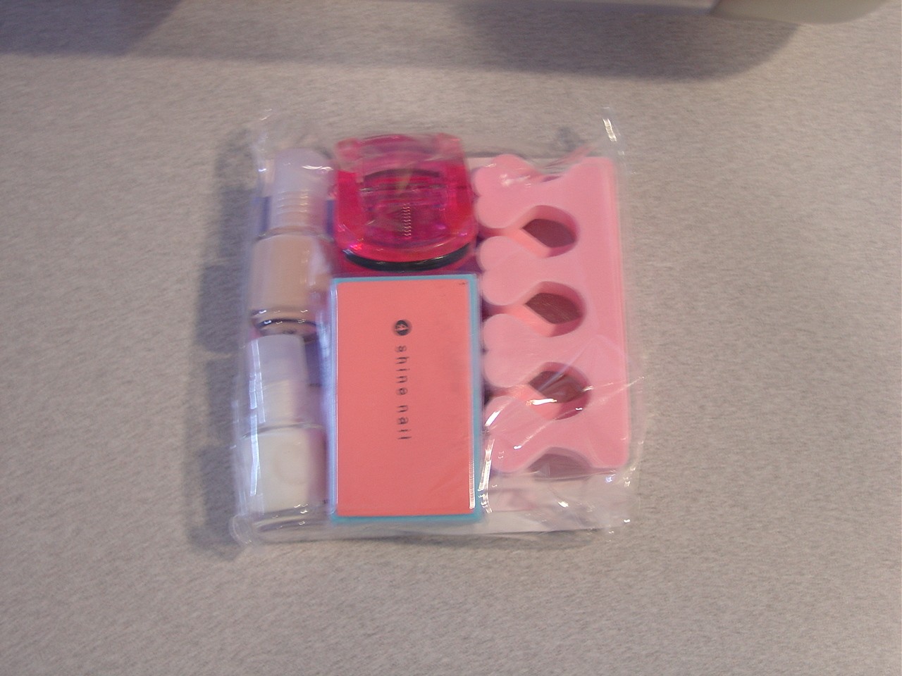 A WHITE AND PINK NAIL VARNISH AS PART OF A MANICURE PEDICURE SET. THE EMERY BOARD, FILE NAIL EDGE , PLASTIC EYELASH CURLER, PLASTIC TOE SEPARATOR WILL BE CLASSIFIED ELSEWHERE IN THE TARIFF.