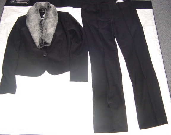 A WOVEN TROUSER SUIT FOR LADIES. UPPER GARMENT IS A SHORT TAILORED JACKET MADE UP OF MANY PANELS.  WITH A RIGHT OVER LEFT CLOSURE WITH BUTTON FASTENINGS. WITH SLIT POCKETS TO LOWER FRONT. WITH LONG SLEEVES. HEMMED AST SLEEVE ENDS. WITH A REVER COLLAR. FULLY LINED.  PRESENTED WITH A DETACHABLE FAKE FUR COLLAR.BOOT-CUT TROUSERS ARE HIPSTERS WITH A WIDE WAISTBAND WITH BELT LOOPS. WITH A ZIP FLY WITH A RIGHT OVER LEFT CLOSURE WITH HOOKS AND EYES. HEMMED AT LEG ENDS. 71% POLYESETER / 25% VISCOSE / 4% SPANDEX TWILL WEAVE.