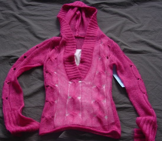 A KNITTED PULLOVER FOR LADIES DESIGNED TO COVER THE UPPER PART OF THE BODY TO BELOW THE WAIST. WITH LONG SLEEVES. WITH A DEEP V-NECKLINE EDGED WITH RIBBING WHICH GOES INTO AN ATTACHED HOOD.. RIBBED AT BASE OF GARMENT. WITH AN ATTACHED COTTON INNER VEST IN A CINTRASTINGCOLOUR. 55% RAMIE, 30% ACRYLIC,15% MOHAIR