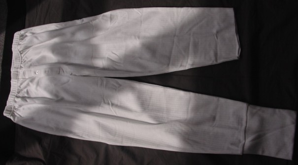 A PAIR OF KNITTED RIBBED LONG JOHNS FOR MEN. WITH AN ELASTICATED WAIST AND A CONCEALED FLY OPENING LEFT OVER RIGHT WITH TWO BUTTON FASTENING. REACHING TO THE ANKLE. WITH APPLIED RIBBED CUFFS AT LEG ENDS.  60% COTTON / 40% POLYESTER.