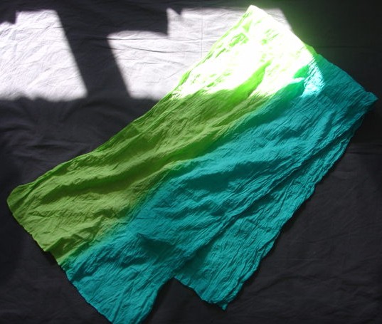WOVEN TEXTILE SCARF. MEASURING 150CM LONG AND 34CM ACROSS. DYED BLUE AND GREEN. HEMMED ON ALL EDGES. MADE FROM 100% COTTON.