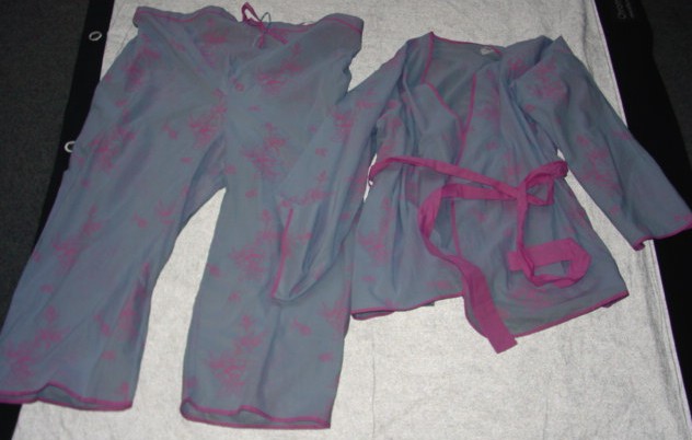 A PAIR OF WOVEN,PRINTED MATERNITY PYJAMAS. UPPER GARMENT IS A WRAP-OVER JACKET, REACHING TO THE HIP.  WITH A CONTRASTING TIE BELT. WITH BELT LOOPS. WITH POCKETS TO SIDE SEAMS. WITH LONG SLEEVES. PACKAGED WITH A PAIR OF CROPPED TROUSERS. WITH A HALF - ELASTICATED WAIST  AND A CONTRASTING DRAWSTRING. ALL EDGES ARE BOUND WITH CONTRASTING BIAS BINDING. 100% COTTON. PRESENTED WITH A BLOUSE AS A THREE PIECE SET. CLASSIFIED SEPARATELY.