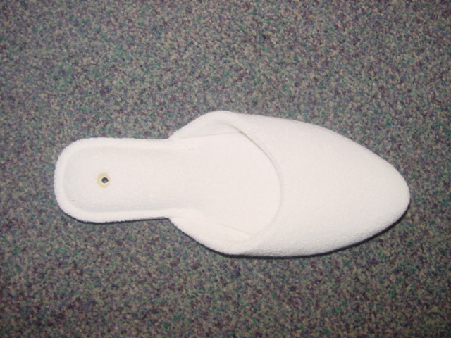 LADIES MULE STYLE SLIPPER. UPPERS OF TEXTILE MATERIAL (TERRY TOWELLING). OUTER SOLES OF SUEDE. INSOLE LENGTH MORE THAN 24CMS. WHITE IN COLOUR.