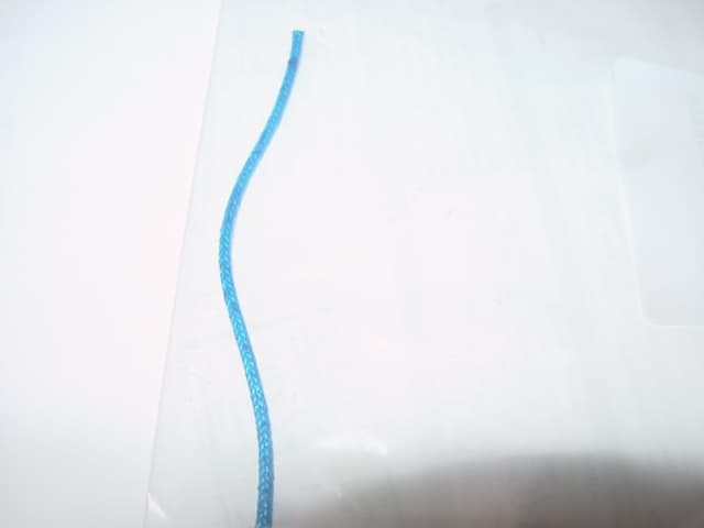 A GLASSFIBRE CORD CONSTRUCTED FROM LITHER COPPER OR NICKEL COVERED WITH A GLASS YARN. FOR INSULATING PURPOSES. APPROX 2MM IN DIAMETER. DYED.