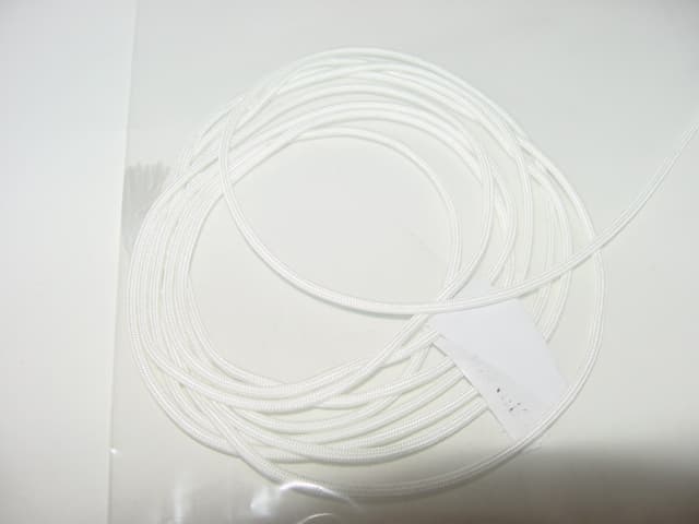 A FLAT GLASS FIBRE BRAID USED AS A HIGH TEMPERATURE INSULATION. APPROX 3MM WIDE.