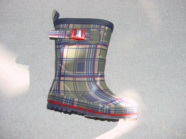 CHILDS WATERPROOF WELLINGTON BOOT.  UPPERS AND SOLES OF RUBBER. COVERING THE ANKLE BUT NOT THE KNEE.  WITH TARTAN PRINT AND BUCKLE TIGHTENING ON ONE SIDE OF THE UPPER. WITH FLEECE LINING.