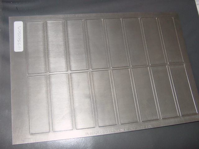 A STEEL DIE. FOR USE IN THE MANUFACTURE OF LABELS ETC. A FLAT SHEET OF APPROX 25 X 17 CMS WHICH IS ATTACHED TO A ROLLER . WITH RECTANGULAR SHAPED CUTTING EDGES FORMING A CUTTING STATION AT THE END OF A PRODUCTION LINE.