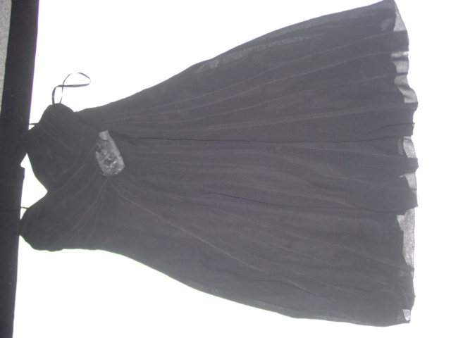 A WOVEN DRESS. DESIGNED TO COVER THE UPPER PART OF THE BODY FROM THE SHOULDERS TO THE KNEE. WITH THIN ADJUSTABLE SHOULDER STRAPS. WITH A V-NECK LINE. WITH AN APPLIED FLOWER AT THE CENTRE. WITH AN INNER LINING. 100% SILK. PRESENTED WITH A INNER DETACHABLE NET PETTICOAT. CLASSIFIED SEPARATELY. ( SEE BTI 113587965)