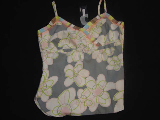 A WOVEN BLOUSE FOR LADIES DESIGNED TO COVER THE UPPER PART OF THE BODY TO BELOW THE WAIST. WITH SHAPED BUST. WITH CROSS OVER VEE NECKLINE. WITH ADJUSTABLE SHOULDER STRAPS. WITH SHAPED HEM AT BASE OF GARMENT. WITH SIDE OPENING FASTENED WITH A ZIP ON THE LEFT HAND SIDE. OF SILK.