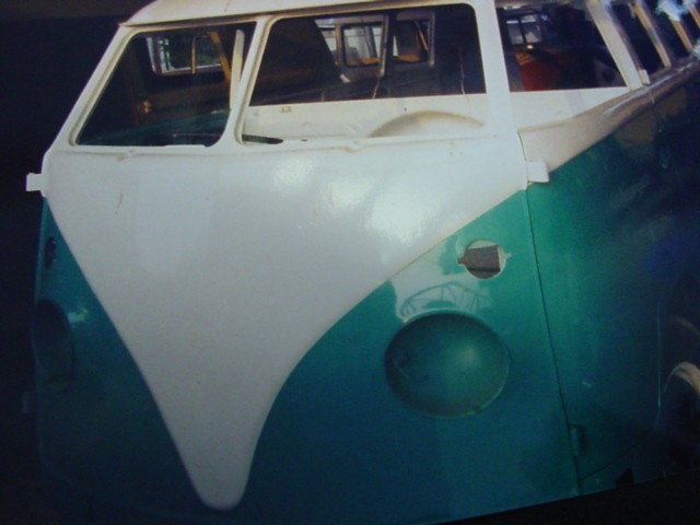 A 1967 WHITE AND GREEN VOLKSWAGON MICROBUS.  IT HAS A SPARK-IGNITION INTERNAL COMBUSTION PISTON ENGINE WITH A CYLINDER CAPACITY OF  1500CC.
