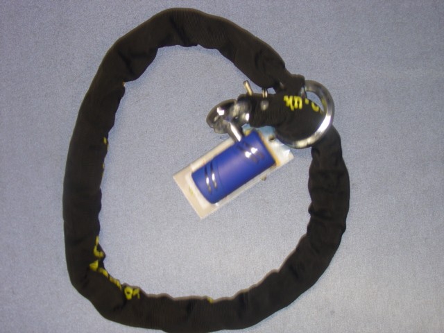 HARDENED CHROME STEEL DISC  LOCK AND CHAIN OF A TYPE USED FOR MOTORCYCLES.  FOR PROTECTION  AGAINST DRILLING, CUTTING AND SAWING AGAINST THEFT. 16 MM DIAMETER HARDENED STEEL LOCK BODY AND PIN. NICKEL CHROME MOLYBDENUM CHAIN FOR PROTECTION AGAINST BOLT CROPPERS AND HACKSAW. COMPLETELY COVERED WITH A TEXTILE MATERIAL. FLAT KEY STYLE WITH THREE KEYS.