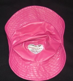 A COWBOY  HAT FOR GIRLS, MADE OF PLASTIC SHEETING. PINK WITH A SILVER HEART TO THE FRONT.LINED WITH TEXTILE. PART OF A FANCY DRESS OUTFIT. CLASSIFIED SEPARATELY.