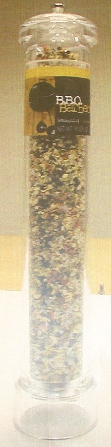 A SEASONING MIX IN A PLASTIC GLASS JAR INCORPORATING A GRINDER IN THE BASE. INGREDIENTS SEA SALT, GARLIC, ONION, CARROT, CHIVE, CHILLI, SUGAR, SPICES. THEY ARE ALL DRIED AND USED TO SEASON FOOD.