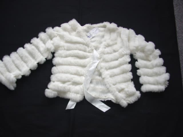 A KNITTED VICTORIAN STYLE TIPPET (SHAWL). WITH A COLLAR. WITH STRIPES OF RABBIT FUR AN FUR TRIM TO ALL EDGES. TIES AT NECK WITH A SATIN RIBBON.