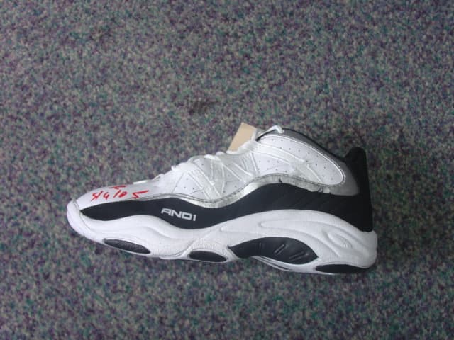 CHILDS ANKLE BOOT. COVERING THE ANKLE BUT NO PART OF THE CALF. UPPERS OF LEATHER AND PLASTIC. LEATHER PREDOMINATES. OUTER SOLES OF RUBBER. WITH LOGO ON HEEL, UPPER AND TONGUE. LACE UPS. INSOLE LENGTH LESS THAN 24 CMS. NO VISIBLE EVIDENCE OF ANY SPECIAL TECHNOLOGY FEATURES. BLACK/WHITE IN COLOUR.