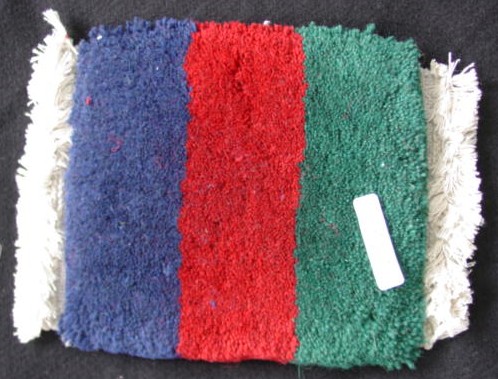 100% MADE UP, DEEP PILE WOOL CARPET OF WOVEN PILE CONSTRUCTION WITH A WOVEN BACKING OF UNSPECIFIED NATURAL MATERIAL. WITH FRINGING.