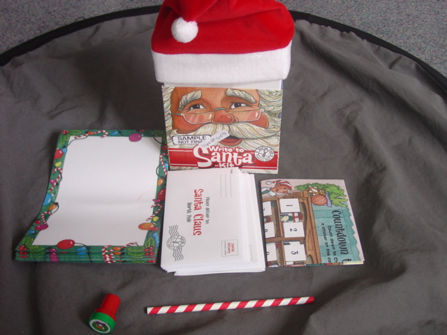 WRITE TO SANTA KIT. CONSISTING OF 10 STATIONERY SHEETS, 10 ENVELOPES, 1 PENCIL, SELF INKING STAMP,  COUNT DOWN TO CHRISTMAS STICKER A DAY CALENDER WITH STICKERS. PACKAGED TOGETHER AS A SET IN A CARDBOARD BOX. THE LID OF THE BOX IS DECORATED WITH A SMALL TEXTILE FATHER CHRISTMAS HAT FIRMLY GLUED TO THE LID.


A SMALL CHILDS STORY BOOK ENTITLED THE GIFT OF THE MAGI PACKAGED WITH THE SET HAS BEEN CLASSIFIED SEPARATELY.