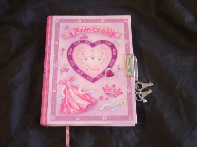 DIARY WITH A LOCK AND KEYS FOR CHILDREN. THE PAGES ARE PINK AND RULED, WITH HEARTS AND FLOWERS ON EACH PAGE. THE WORD 'DATE'  IS PRINTED AT THE TOP OF EACH PAGE WITH A SPACE TO WRITE THE DATE IN. THE PAPER BOARD COVER OF THE DIARY IS DECORATED WITH GLITTER AND RHINESTONE JEWEL DECORATIONS.
THE DIARY IS PACKAGED IN A DECORATED PAPERBOARD BOX TOGETHER WITH TWO BLISTER PACKS CONTAINING STICKERS, BEADS, SEQUINS, JEWELS, PEN, GLUE AND GLITTER GLUE. THE BOX, AND BLISTER PACKS CLASSIFIED SEPARATELY.
